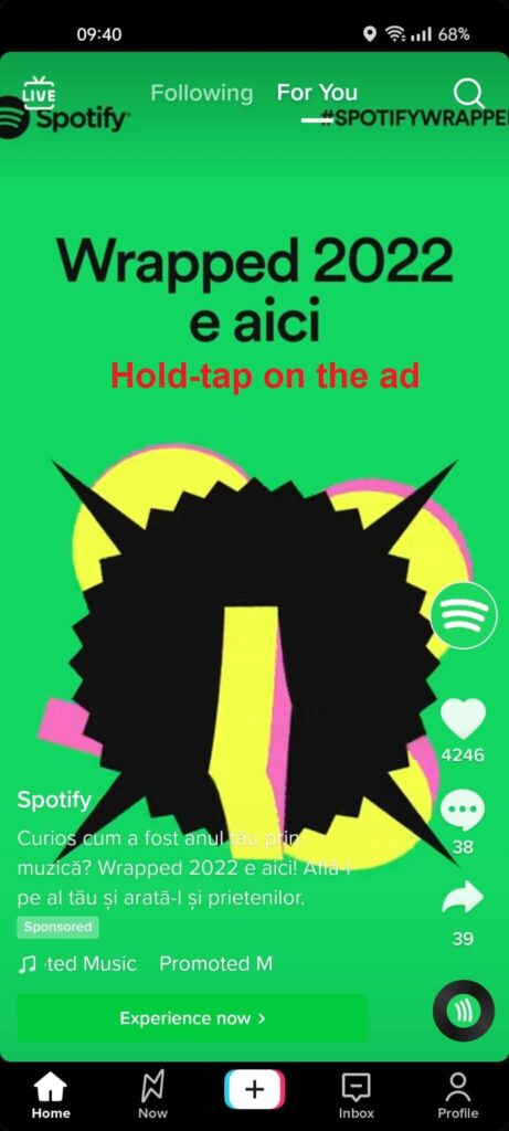 TikTok ad screen with the "Hold-tap on the ad" text showing in red