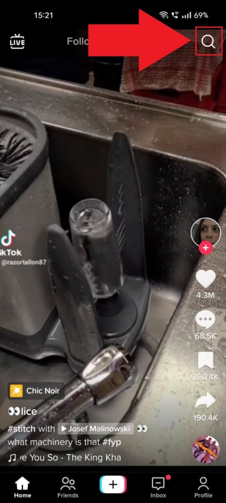 TikTok feed where the magnifying glass (Search) icon is highlighted in red
