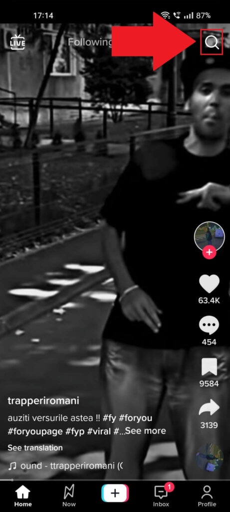 TikTok feed showing the "Search" (magnifying glass) icon highlighted in the top-right corner