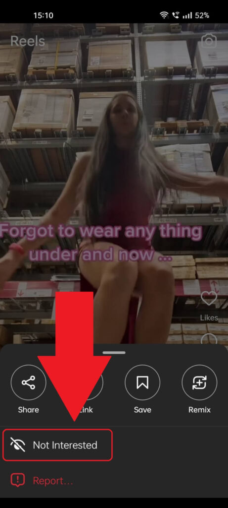 Instagram Reel menu where the "Not interested" option is highlighted in red and has a red arrow pointing to it