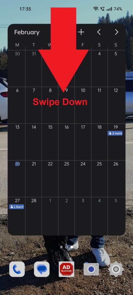 Android homescreen showing a red arrow pointing down from the top of the screen next to a text saying "Swipe down"