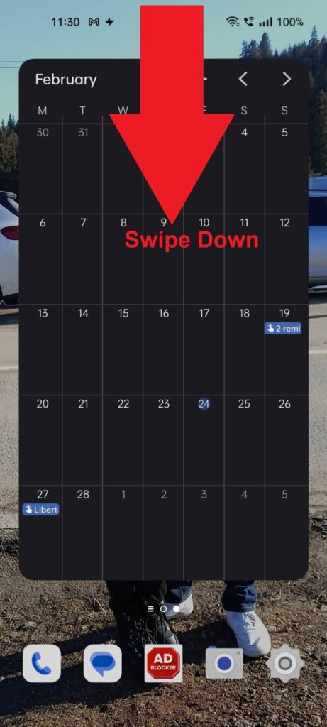 Android phone showing a red arrow pointing down from the top of the screen and the "Swipe Down" message under it